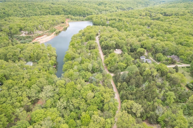 drone / aerial view with a wooded view and a water view