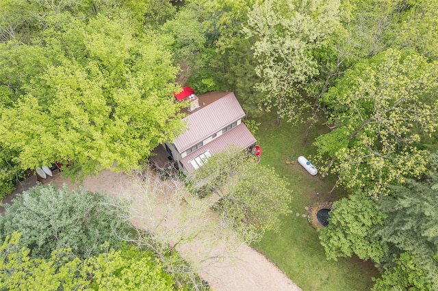 birds eye view of property with a view of trees
