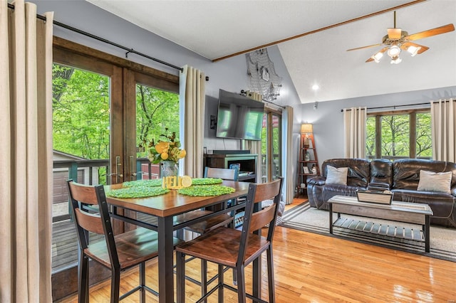 dining space featuring a ceiling fan, wood finished floors, and lofted ceiling