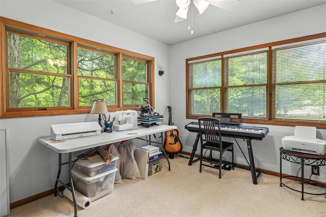 office area featuring carpet, a textured ceiling, baseboards, and ceiling fan