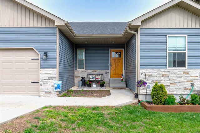 property entrance with an attached garage and stone siding