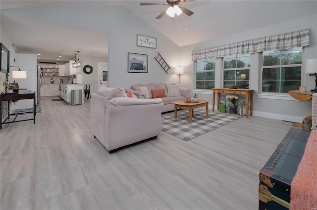 living area with ceiling fan, baseboards, lofted ceiling, and light wood-type flooring