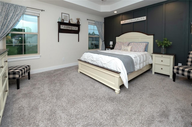 carpeted bedroom with multiple windows and baseboards