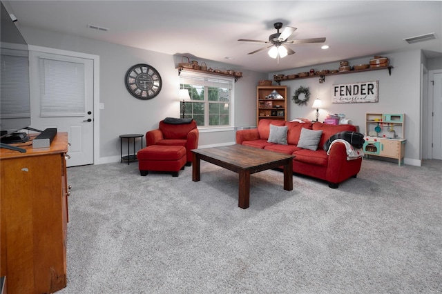 living room featuring a ceiling fan, baseboards, visible vents, and carpet