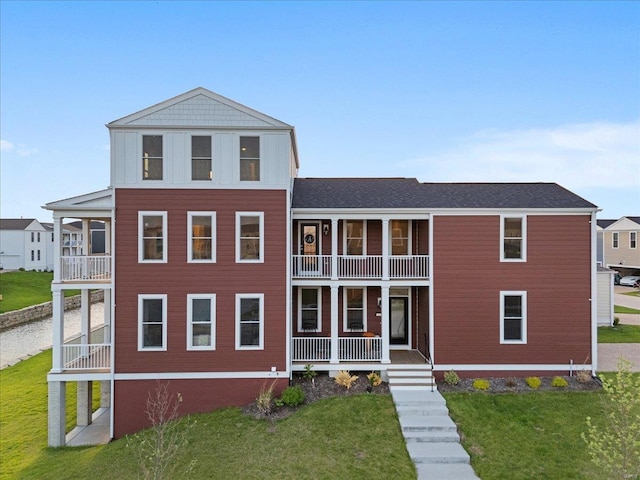 view of front of home with a porch, a front lawn, and a balcony