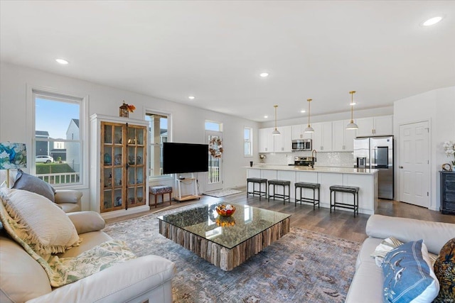 living room with recessed lighting and dark wood finished floors