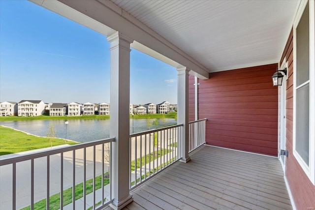 balcony with a water view and a residential view