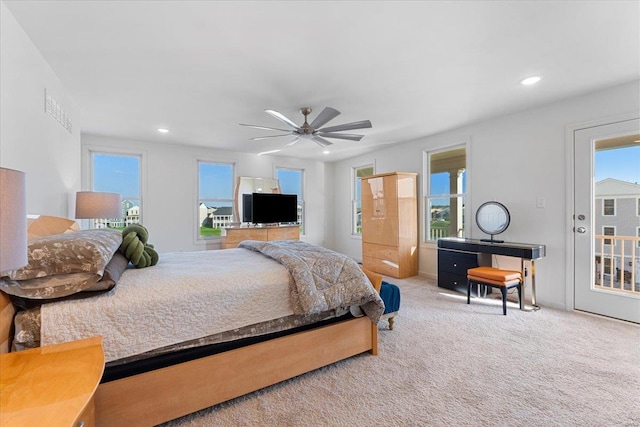 carpeted bedroom featuring recessed lighting, ceiling fan, multiple windows, and access to exterior