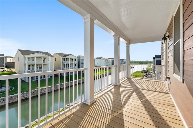balcony featuring a water view and a residential view