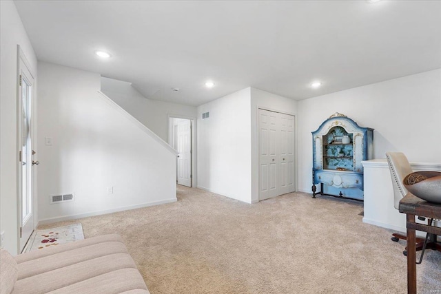 interior space featuring recessed lighting, baseboards, visible vents, and light carpet