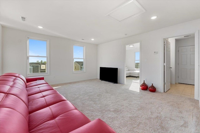unfurnished living room featuring carpet, attic access, recessed lighting, and visible vents
