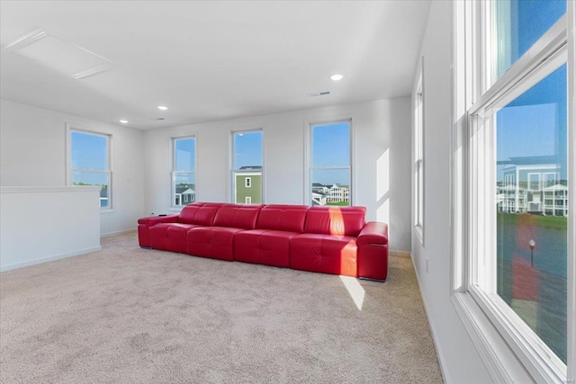 living area with recessed lighting, carpet, and a wealth of natural light