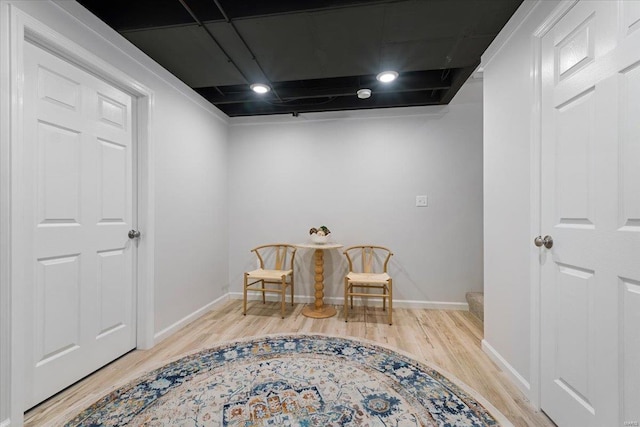 living area featuring baseboards and light wood-style floors