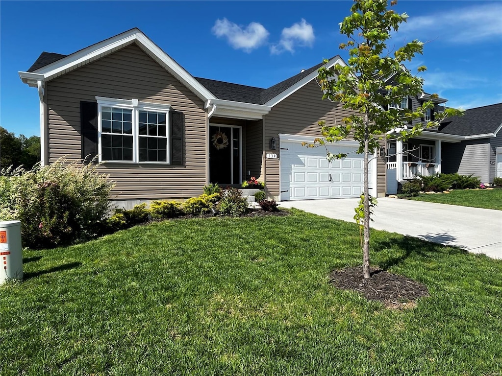 single story home with an attached garage, driveway, and a front yard