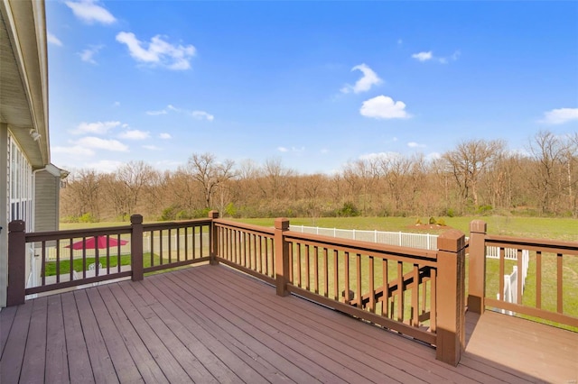 wooden terrace with a lawn