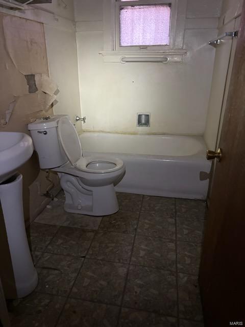 full bathroom featuring tile patterned flooring and toilet