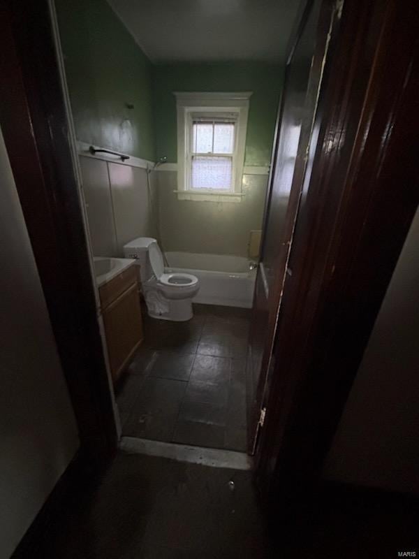 full bathroom with toilet, a washtub, tile patterned floors, and vanity