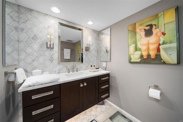 bathroom featuring vanity, recessed lighting, baseboards, tasteful backsplash, and visible vents