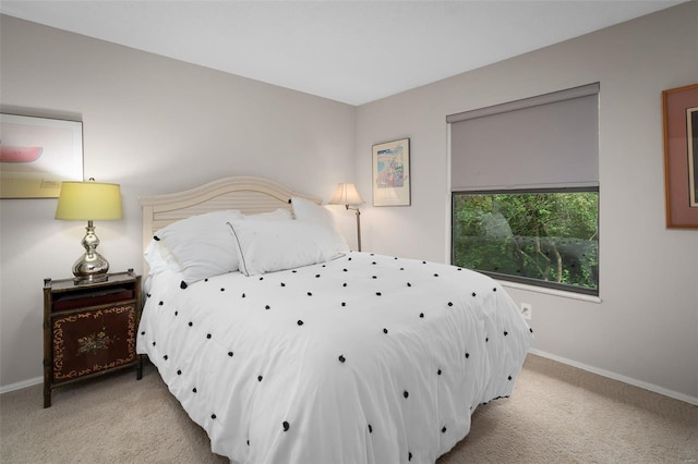 bedroom featuring baseboards and carpet flooring