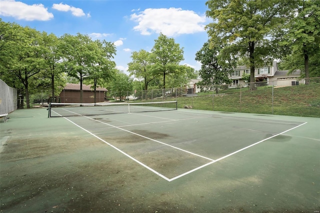 view of sport court featuring fence