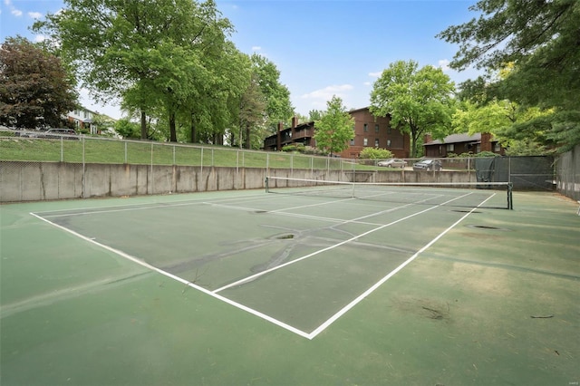 view of tennis court featuring fence