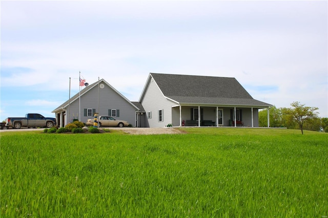 rear view of house with a yard and covered porch