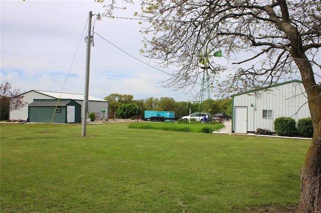 view of yard with an outbuilding, an outdoor structure, and a garage