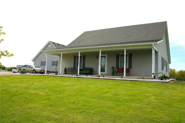 view of front facade with covered porch and a front lawn