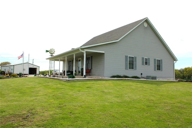 rear view of house featuring a garage and a yard