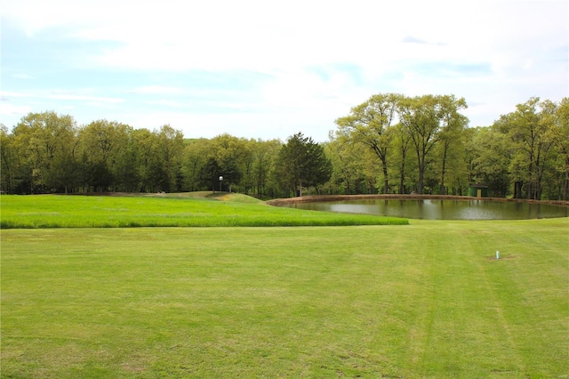 view of home's community featuring a lawn and a water view