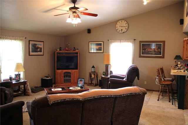 living room featuring light tile patterned floors, a ceiling fan, and lofted ceiling