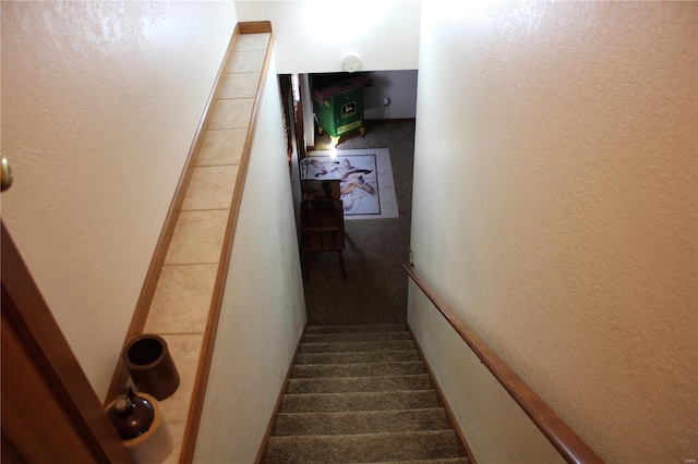 staircase with a textured wall and carpet