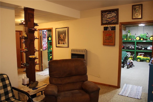 living area featuring baseboards, carpet flooring, and heating unit