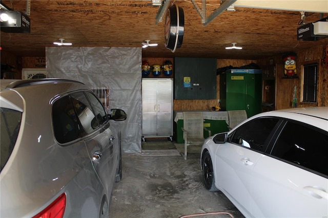 garage with a garage door opener and electric panel