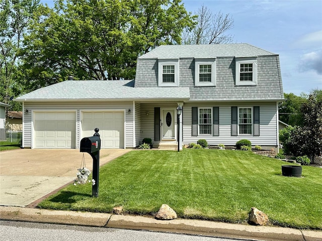 view of front of home featuring a shingled roof, an attached garage, a front lawn, a gambrel roof, and concrete driveway