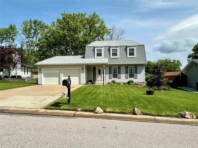 traditional-style home featuring roof with shingles, a garage, a gambrel roof, concrete driveway, and a front lawn