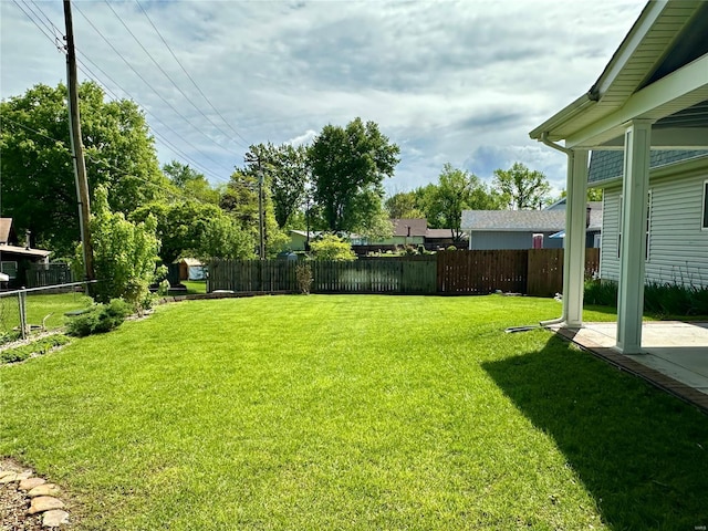 view of yard featuring fence and a patio