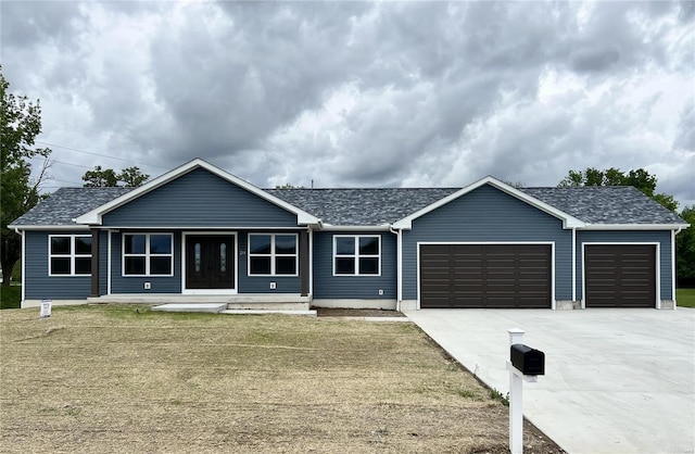 ranch-style house featuring an attached garage, a front lawn, a porch, and concrete driveway