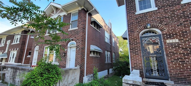 view of side of property with brick siding