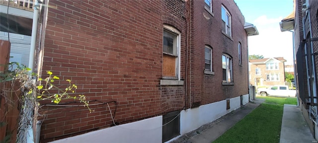 view of side of property featuring brick siding