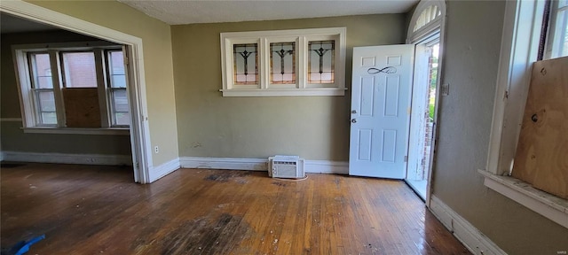foyer entrance with baseboards and wood-type flooring