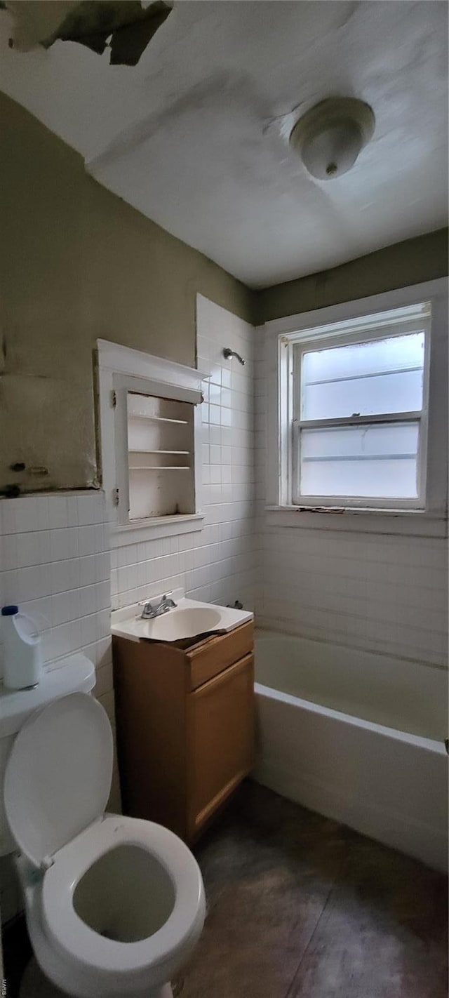 full bathroom featuring shower / bathing tub combination, tile walls, tile patterned flooring, vanity, and toilet