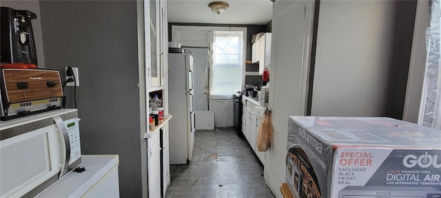 kitchen featuring wood finished floors, white appliances, washer / clothes dryer, light countertops, and white cabinetry
