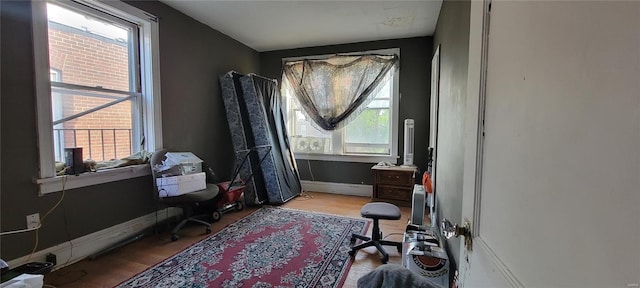interior space featuring baseboards and wood finished floors