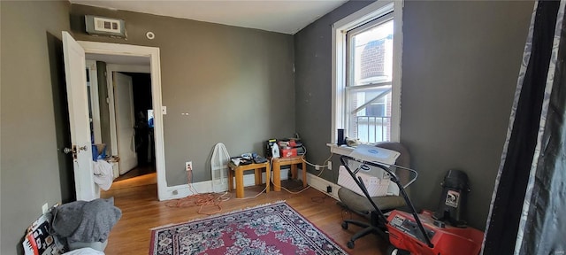 office with baseboards and wood finished floors