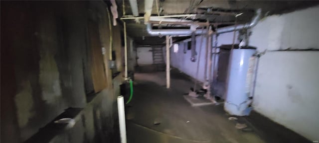 unfinished basement featuring gas water heater