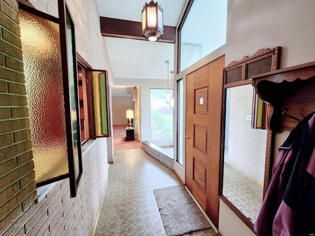 foyer featuring a towering ceiling and tile patterned floors