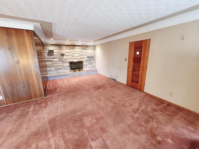 unfurnished living room featuring carpet floors, visible vents, and a fireplace