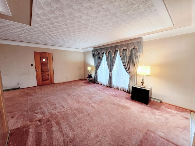 unfurnished living room featuring carpet flooring, crown molding, and baseboards