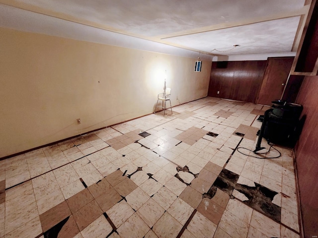 empty room featuring baseboards and light floors